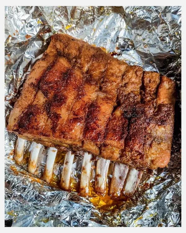 A full rack of my grilled pork spare ribs, marinated overnight in a homemade spice rub and slow-grilled for six hours until the meat is fall-off-the-bone tender.