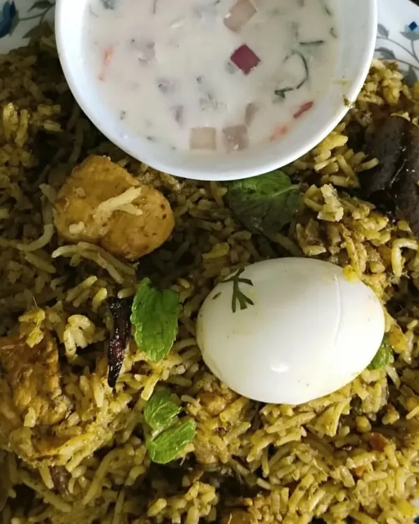 My Gongura Chicken Biryani, a tangy and spicy specialty from Andhra. The unique flavor comes from the gongura (sorrel leaves) paste, served here with a boiled egg and fresh raita.