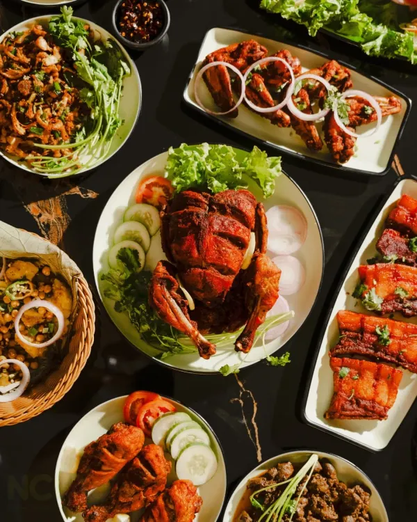 A beautiful spread of my non-veg specialties. You can see a whole fried chicken, pork ribs, chicken legs, and a spicy 'singju' salad, perfect for any celebration.