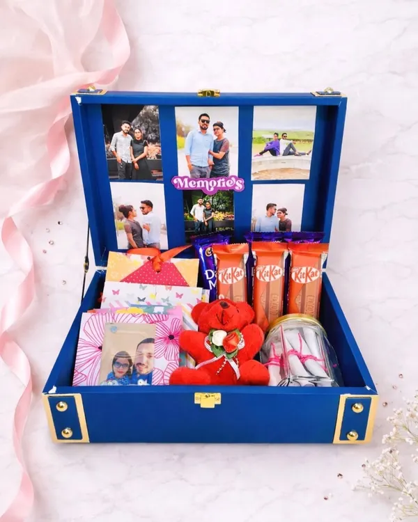 This is what a box full of memories looks like. I created this royal blue trunk hamper with a personalized photo collage inside, filled with chocolates, a teddy bear, and other little surprises. It’s a gift that tells a story.