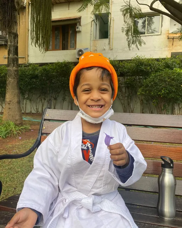 Nothing beats a big smile during an outdoor karate session. This little student is enjoying the fresh air while learning new skills, showing that fitness for kids can be pure fun.