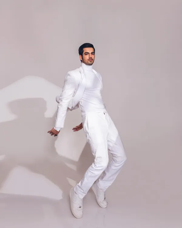 A minimalist all-white look styled for designer Line by Shamim Khan. The cropped jacket and clean lines create a modern and sharp silhouette, showcasing a contemporary take on the classic pantsuit.