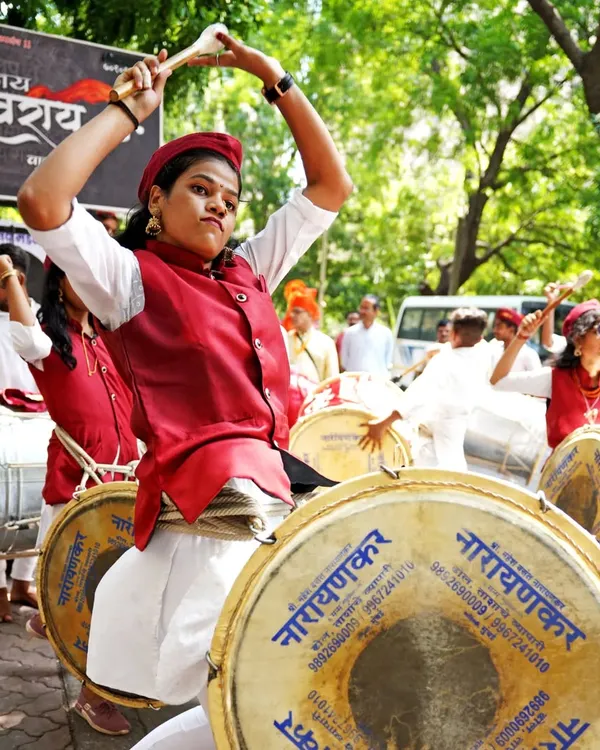 The passion of performance on full display. This dhol player is captured mid-motion, showcasing the intensity and skill involved in the Gudi Padwa celebrations.