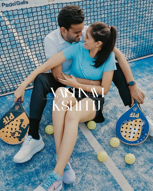 A fun and romantic themed shoot on a Padel court, with the couple seated amidst rackets and balls.