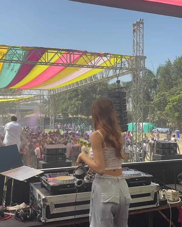 My view from the stage during a Holi festival. The colorful canopy, the massive sound system, and the huge crowd covered in gulal made for an unforgettable experience. I love playing daytime festival sets.