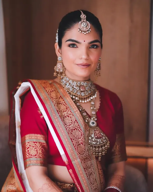 My stunning bride Aishwarya, the epitome of South Indian bridal elegance. I created a classic look with clean, defined eyes and radiant skin to complement her beautiful red and white silk saree.