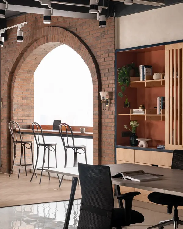 An office should inspire creativity. I designed our own studio with a statement brick arch to frame the large window, creating a bright space for brainstorming or a quiet coffee. It’s a nod to a warm, rustic style that feels both refined and welcoming.