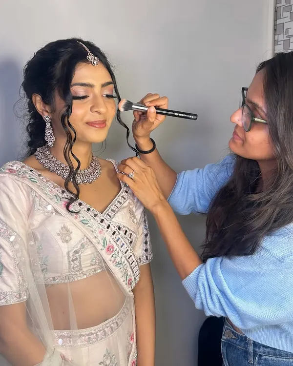 A candid moment of me in my element, adding the finishing touches to a beautiful client's makeup for her special event.