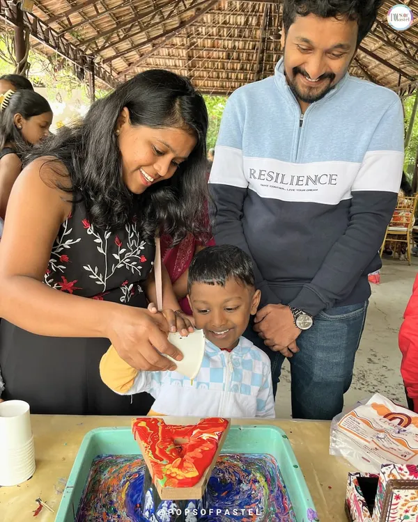 This is what it's all about: pure family fun. We love seeing parents and kids get creative together, like in this fluid art session where they're making a personalized initial. It's moments like these, filled with smiles and a little bit of paint, that become cherished memories.