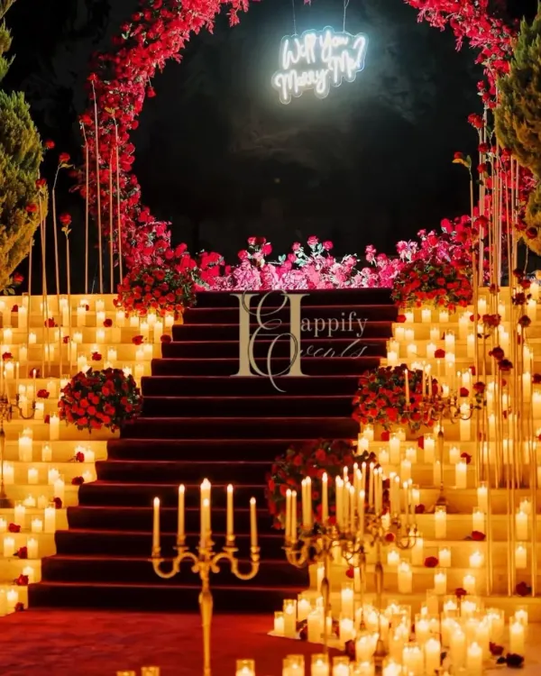 This is what turning a dream into reality looks like. For this grand proposal in Karjat, I used hundreds of candles and a cascade of red roses to create a dramatic, unforgettable pathway. The glowing "Will You Marry Me?" sign at the top of the stairs adds that final, magical touch for a truly cinematic moment.