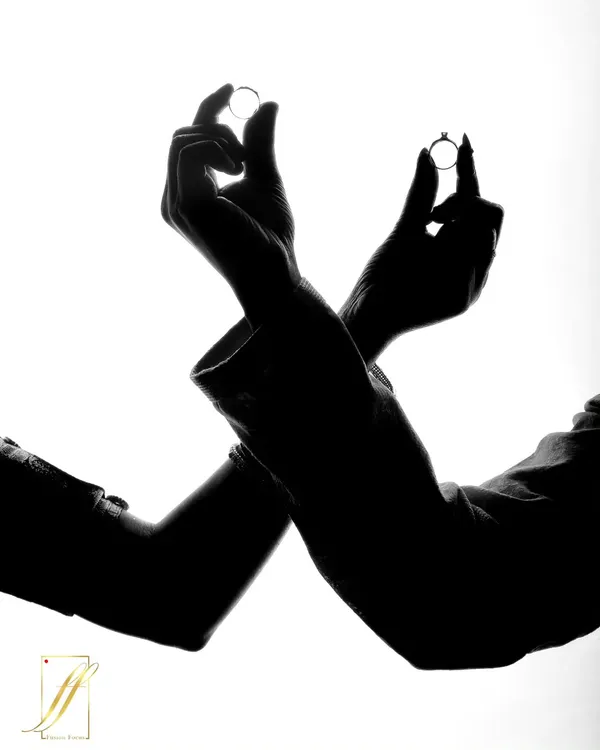 A creative silhouette shot focusing on the rings. This artistic approach creates a dramatic and timeless image that symbolizes the union of two people.
