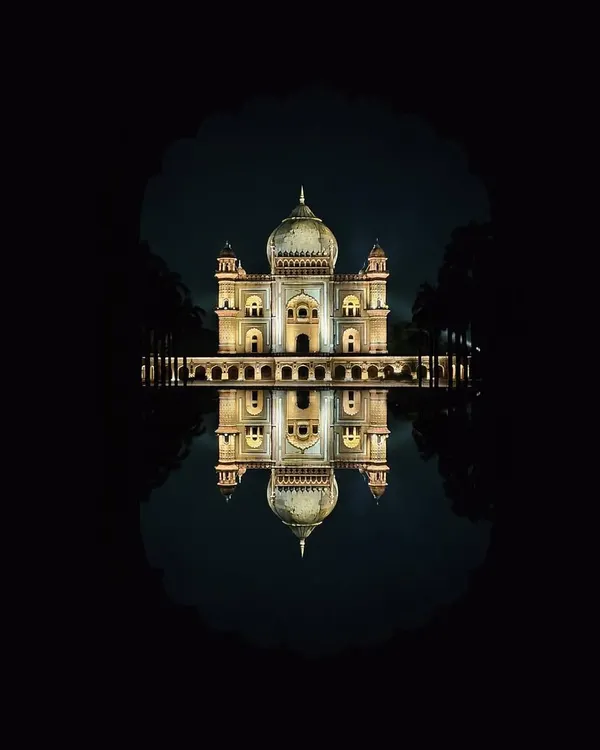 Safdarjung's Tomb illuminated at night, its reflection captured in the water feature, framed by a traditional Mughal arch. This is a shot I took for an OPPO campaign.