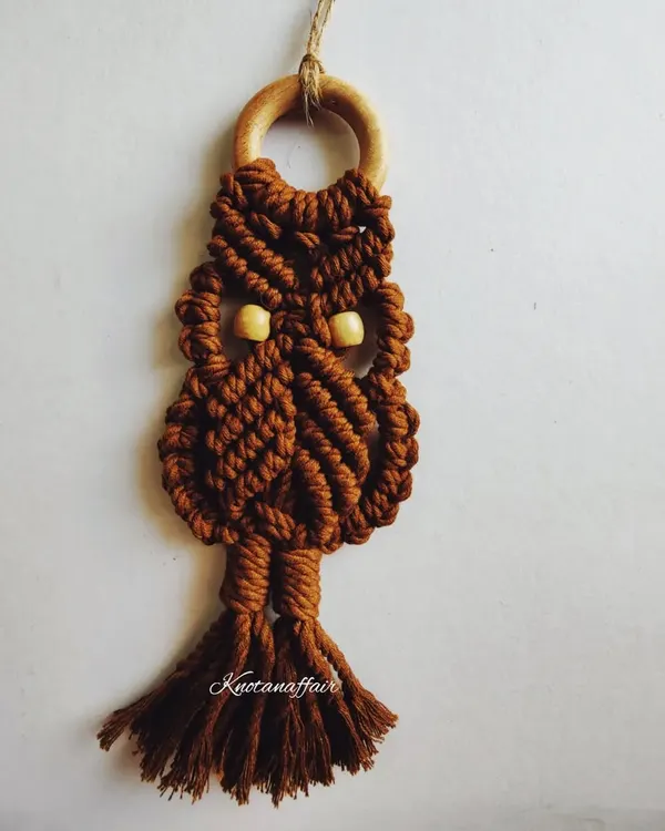 This versatile macrame owl in a lovely brown can be used as a small wall hanging, a bag tag, or even a keychain. It's a perfect boho gift, made with eco-friendly cotton cords and customizable in your choice of colors.