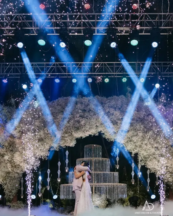 This is what a masterpiece celebration looks like. For this sangeet, I created a dramatic stage with a massive baby's breath floral arch, sparkling pyrotechnics, and dynamic lighting to frame the couple's magical moment.