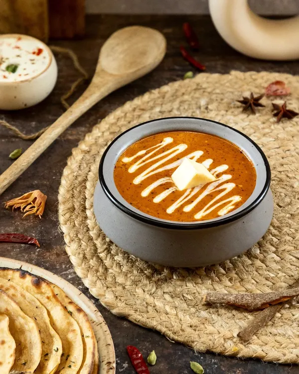 This shot captures the heart of North Indian cuisine. I used dark, moody lighting to emphasize the rich texture of the curry and the creamy swirl, making this classic dish feel both comforting and luxurious for a restaurant's menu.