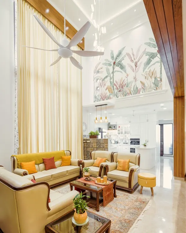 This is where my design philosophy comes to life. I transformed this penthouse living area with a double-height ceiling into a warm, inviting space that balances grandeur with comfort. The hand-painted mural, custom lighting, and open-plan layout leading to the kitchen show how I handle large-scale projects, ensuring every element works in harmony to create a home with soul.