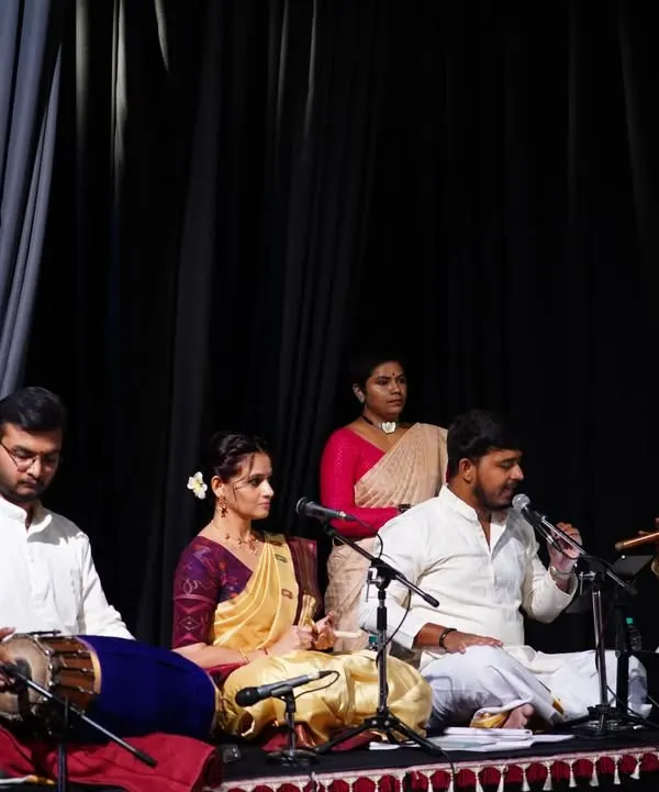 A glimpse into the soul of our performances, where music and dance become one. Here, you see our live orchestra, featuring talented vocalists, the melodic flute, and the rhythmic pulse of the mridangam, all coming together to create a truly divine experience on stage.