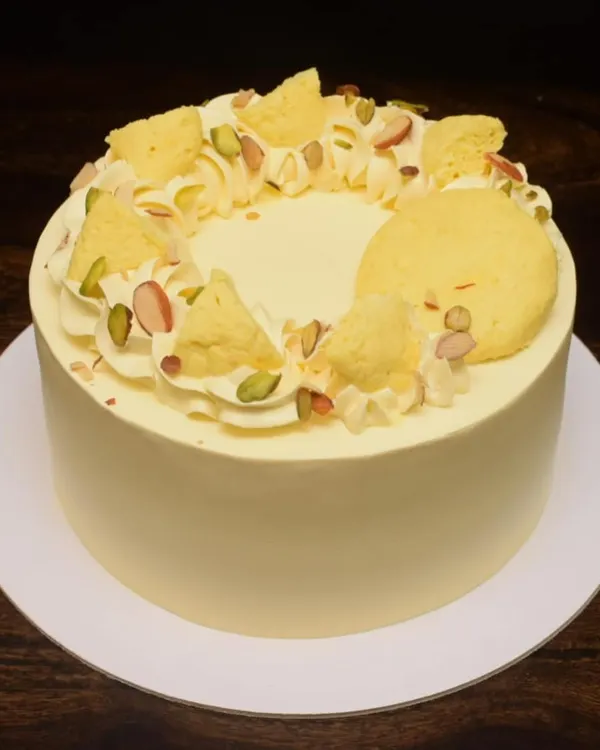 My Rasmalai fusion cake is a consistent bestseller. This one has a clean, smooth finish and is topped with pieces of rasmalai, pistachios, and saffron threads for an elegant and delicious dessert.