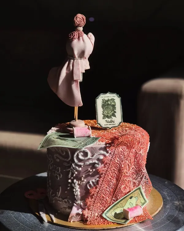 This custom cake was made for a fashion student, and I had so much fun with the details. It features a handcrafted mannequin, edible fabric draping, and other design elements to capture her passion.