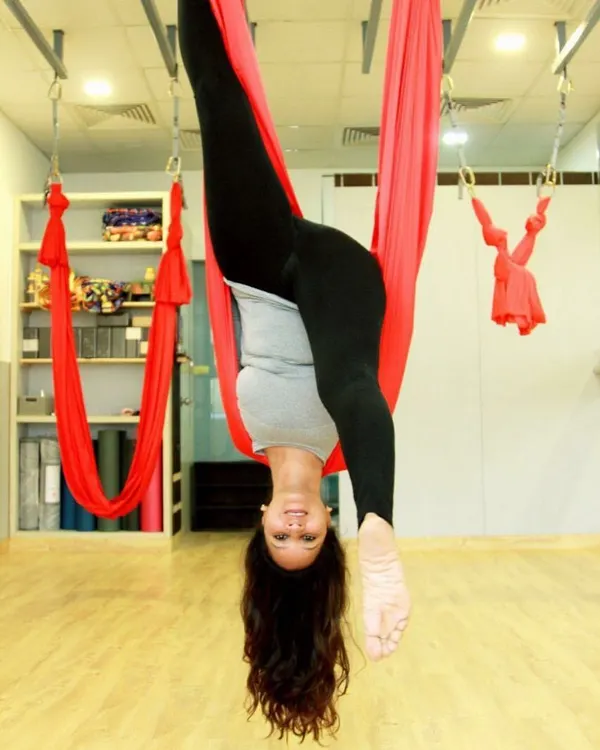 Hanging upside down is not just fun, it's fantastic for your spine. This inversion uses the aerial hammock to create space between the vertebrae, offering relief from back pain and improving posture.