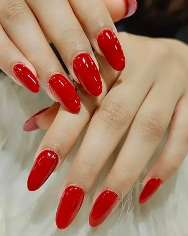 A classic, glossy, and perfectly shaped set of bright red almond nails. A timeless look that is always in style.