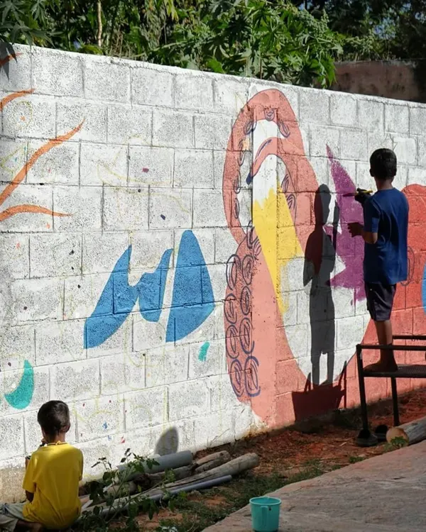 This is what pure, unfiltered creativity looks like. I just provide the wall and the paint, and these amazing kids from Project Defy bring the magic. This is the heart of my work: creating collaborative art that belongs to everyone and builds lasting connections within the community.