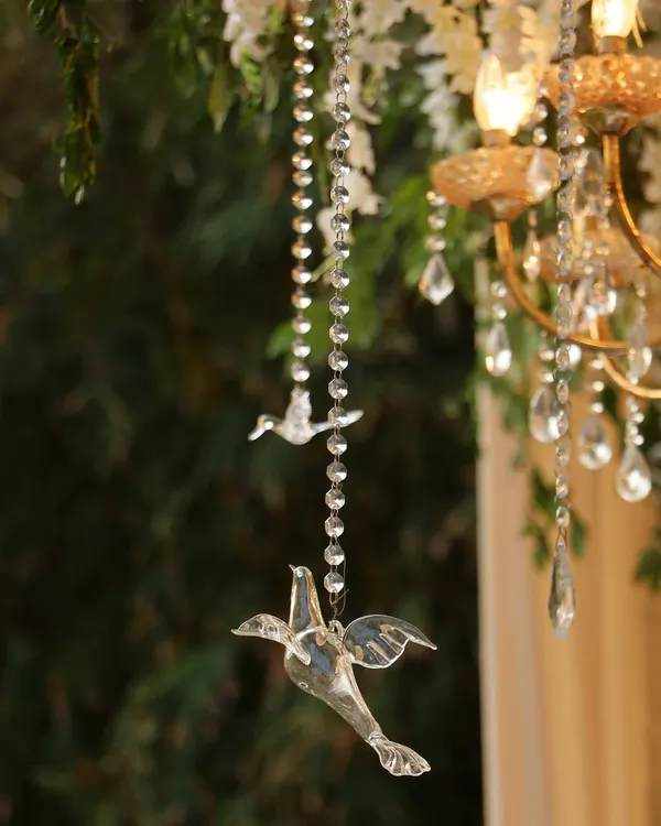 It's all in the details. These delicate crystal birds hanging from beaded strings were part of a larger floral installation, adding a touch of whimsy and sparkle that catches the light and the eye.