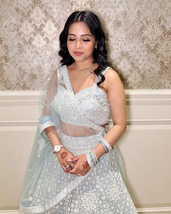 A lovely client ready for a party in a light blue lehenga. I gave her soft curls and a natural makeup look.