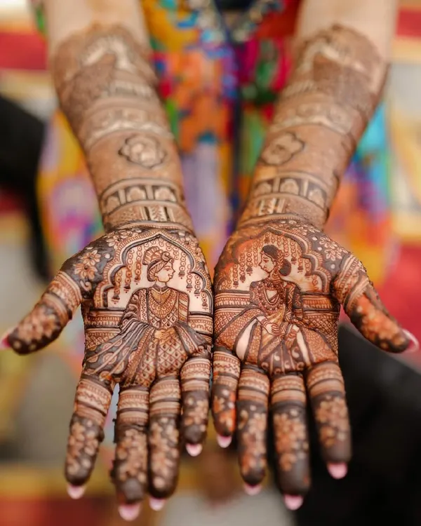 The heart of the wedding story, captured in henna. This design features intricate portraits of the bride and groom on each palm, ready to come together in a beautiful union.