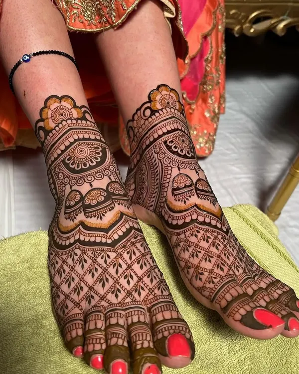 A full-coverage bridal foot mehndi design. The intricate jaali (net) pattern covers the entire foot, with a beautiful cuff design around the ankle.