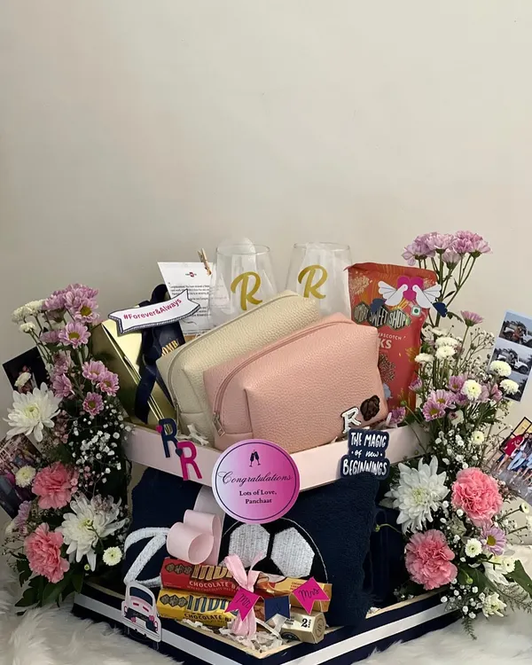 This hamper was a dream to create for a couple who are total opposites. I combined his love for football with her love for animals, using personalized pouches, towels, and wine glasses to tell their unique story. It’s all about weaving those personal quirks into a gift that feels like them.