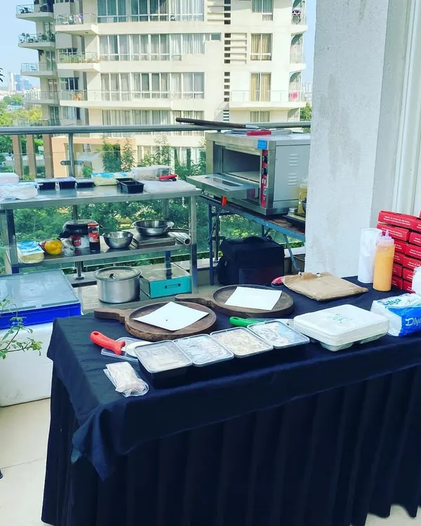 I can transform any space into a professional live cooking station, like this private birthday party setup on an apartment balcony. My service includes all equipment, from the portable oven to the prep tables, ensuring a seamless catering experience for you and your guests.