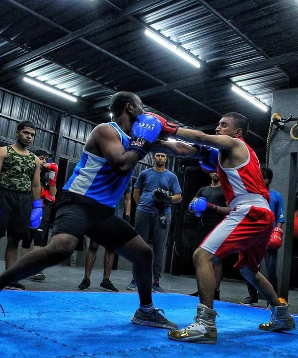 This is what a sparring day looks like. Two fighters testing their skills in the ring while the rest of the club watches and learns. It’s all about controlled aggression and sharp technique.
