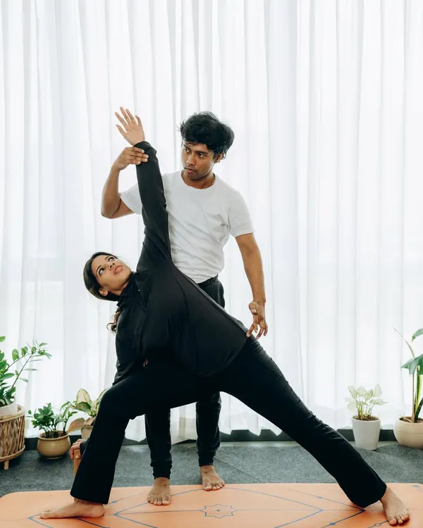 The foundation of our teacher training is learning to see and guide the body with precision. Here, I am providing a hands-on adjustment in Utthita Trikonasana (Extended Triangle Pose), ensuring the student's spine is elongated and the shoulders are open. This focus on alignment is what makes your future teaching safe, effective, and transformative for your own students.