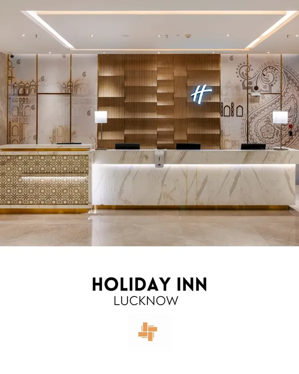 The main reception of Holiday Inn, Lucknow, serves as a contemporary welcome infused with local culture. The design features a sleek Italian marble desk, a textured wood backdrop, and wall graphics that echo the city's architectural motifs.