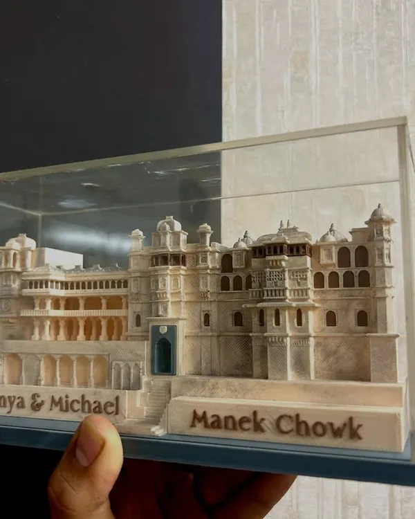 To make guests feel truly special, I design unique wedding favors like this custom 3D model of the Manek Chowk palace. It's a memorable keepsake that tells a story and honors the heritage of the wedding venue.