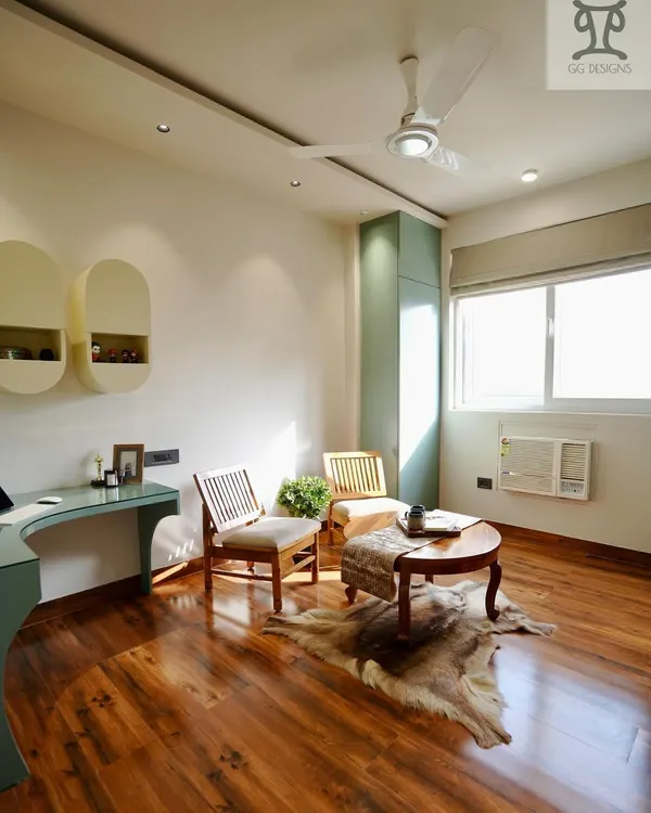 This sun-lit study room was designed to be a bright and comfortable multi-use space. It features a custom desk, ample natural light from the large window, and a cozy seating area for breaks or casual conversations.