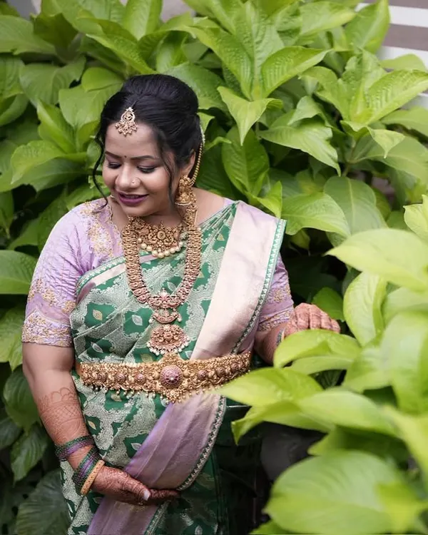 I believe motherhood is a divine journey, and our client Pavithra glows in this exclusive lavender and green silk saree for her baby shower. The rare dual-tone silk and hand-embroidered zari motifs make this an heirloom piece, perfect for celebrating life's most precious beginnings.