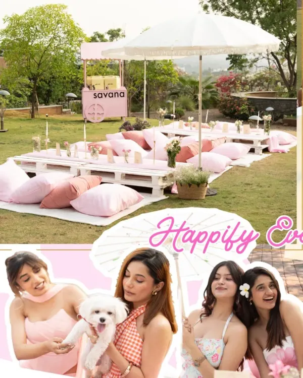 A dreamy puppy picnic setup for a brand event, featuring low pallet tables, plush pink cushions, and elegant white umbrellas for a chic and comfortable outdoor experience.