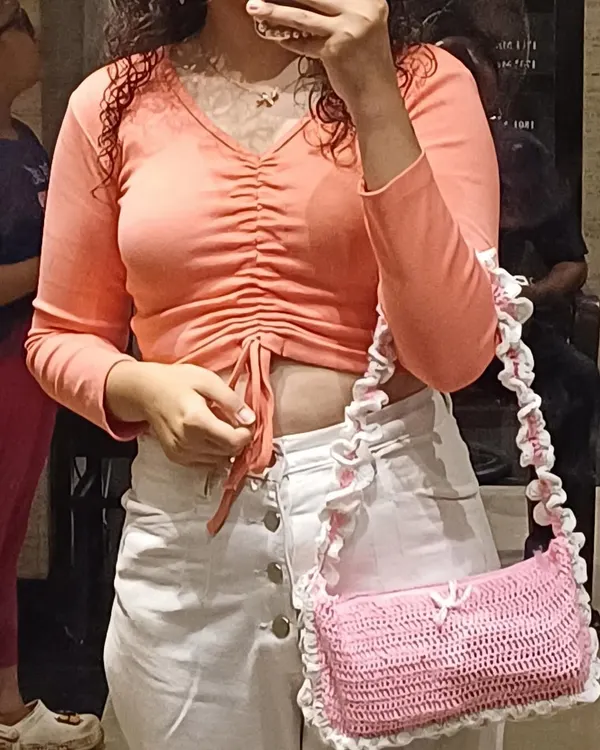 Another look at the pink ruffle bag being worn. It's a shoulder bag style that sits really comfortably and adds a cute touch to any outfit.