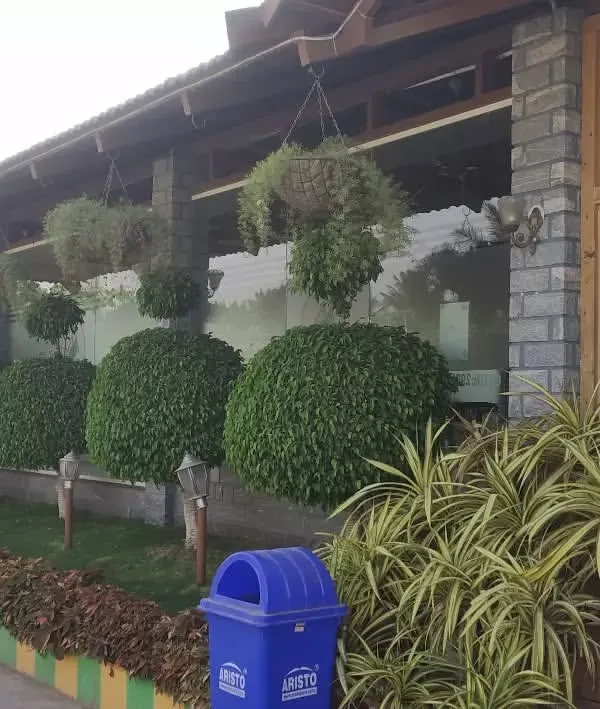 A full view of our landscaping work for a commercial venue. The combination of manicured topiary, lush ground cover, and overflowing hanging baskets creates an impressive and well-maintained exterior that draws people in.