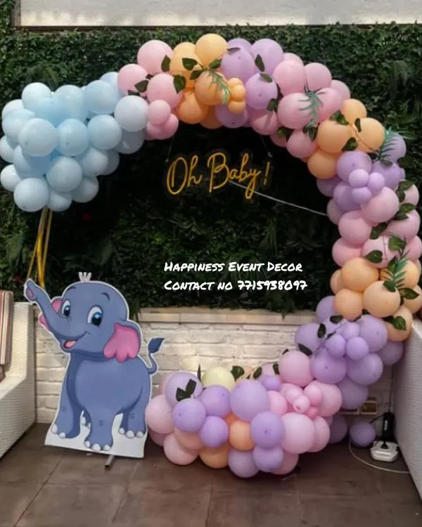 This is a fun and modern baby shower ring decoration perfect for outdoor or indoor parties. The pastel balloon garland is accented with a cute elephant cutout and a golden 'Oh Baby!' sign in the center.