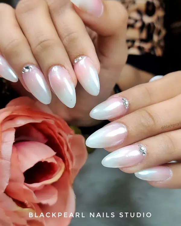 The ultimate bridal nails. This set features a classic baby boomer ombré with a pearl chrome finish and delicate Swarovski crystal accents for a touch of timeless glamour.
