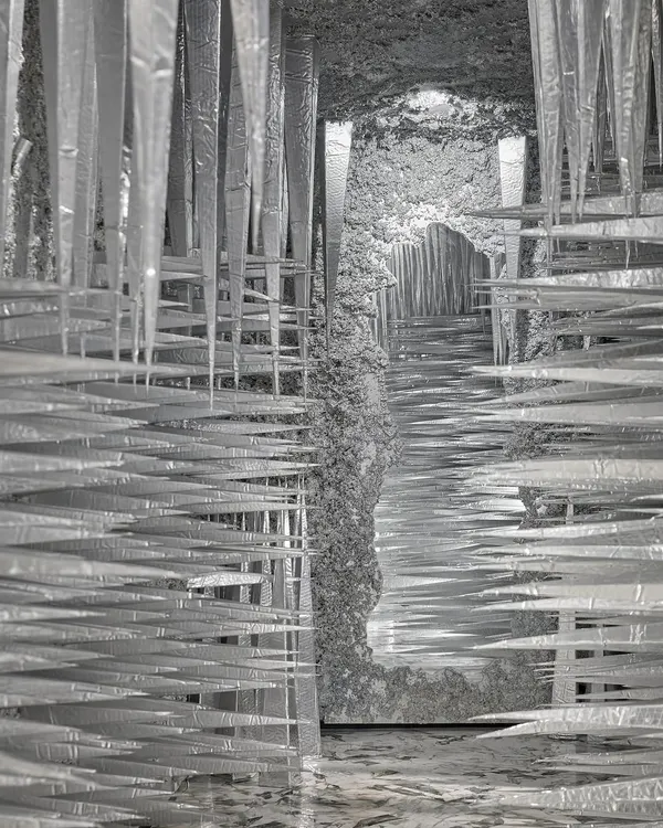 This is the 'Palate Cleanser', an immersive passage we designed to reset the senses. The installation uses sharp, conical foam structures, mirrored surfaces, and dramatic lighting to create a sculptural illusion, snapping visitors into a state of heightened awareness between exhibition spaces.