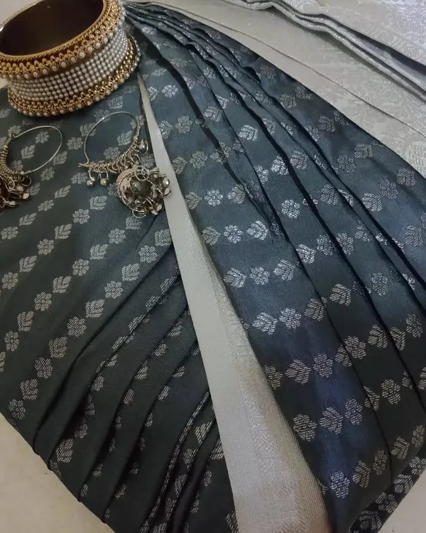 A beautifully pre-pleated and folded dark green saree, ready to be delivered. I've paired it with some jewelry to show how you can style it.