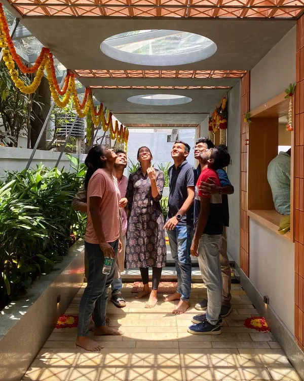 Our team stands in the spotlight of a circular skylight at a recently completed project. This entryway was designed to track the sun's movement, creating a moving circle of light that brings a sense of ritual to daily life.