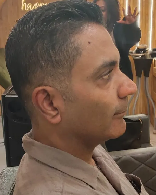 A side profile view showcasing the clean lines and seamless blend of a classic men's haircut. Precision is key to a style that looks great from every angle.