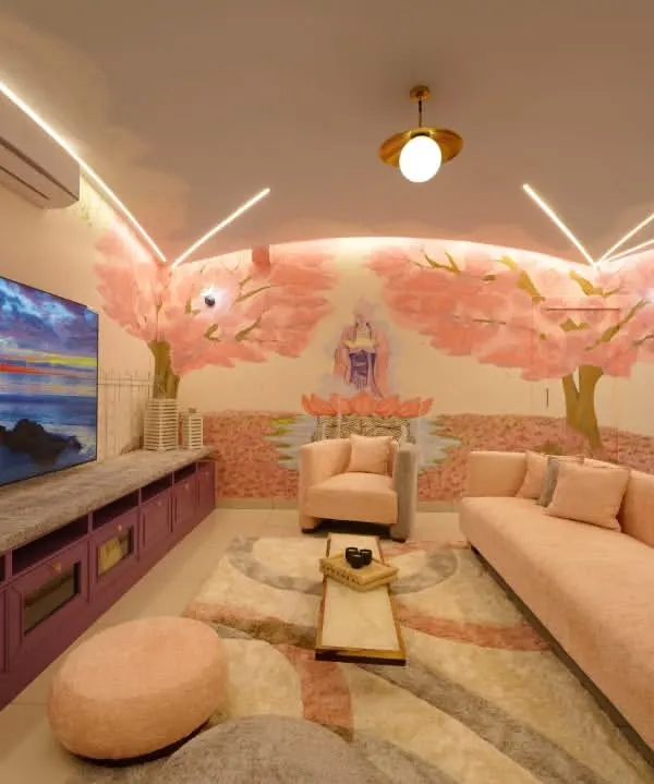 This living room from my 'Sakura' project is where art and architecture breathe as one. The hand-painted cherry blossoms flow across the walls and curved ceilings, wrapping the home in nature’s embrace. The design uses soft LED lines, a serene Buddha mural, and plush, muted tones to create a peaceful retreat that is both luxurious and deeply personal.