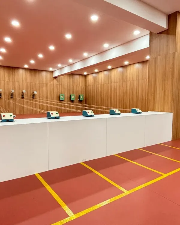 A wide view of our pristine, 10 meter indoor shooting range at the Nalapad Academy. The facility is equipped with modern target systems and excellent lighting, creating a professional environment for all shooters.