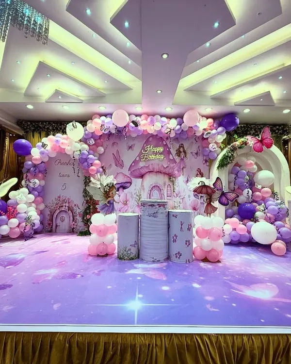 I love creating magical worlds, and this enchanting fairyland theme is a perfect example. The grand setup features a custom-printed backdrop with mushroom houses, surrounded by whimsical balloon toadstools and glowing butterflies, creating a truly immersive experience for a milestone birthday.